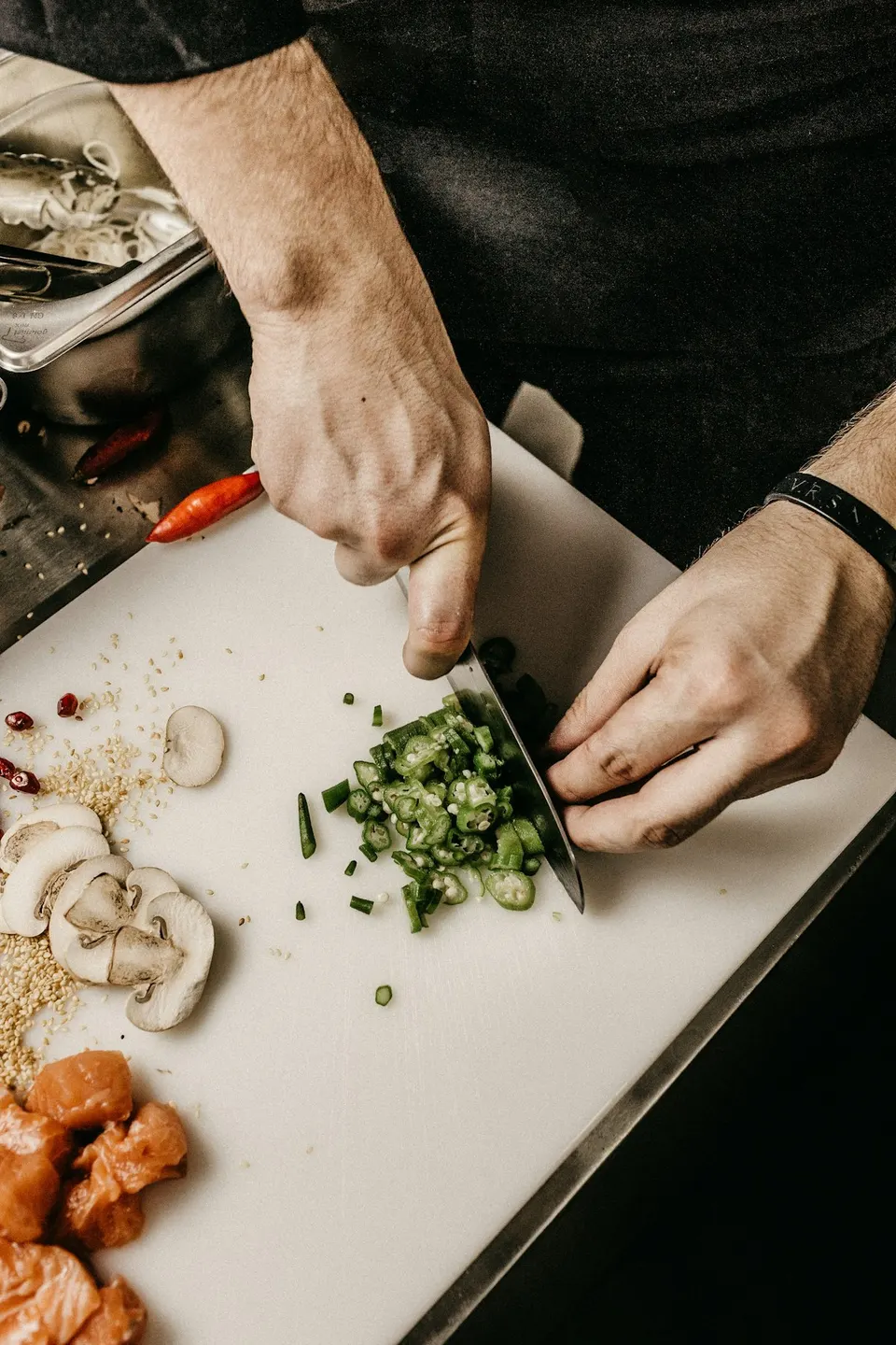 Chef plating fresh ingredients in a restaurant kitchen