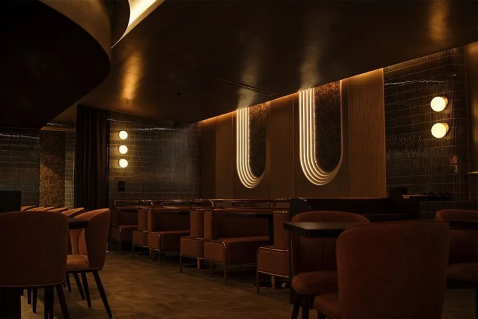 Warmly lit dining room with arched lighting at Bansho
