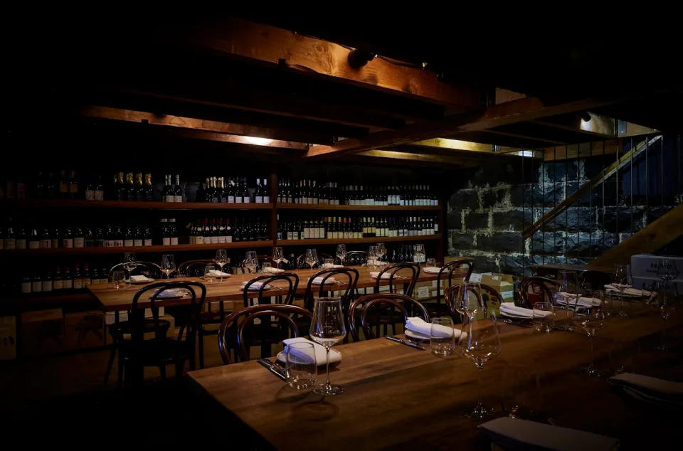 Candlelit dining room and wine wall at the Carlton Wine Room